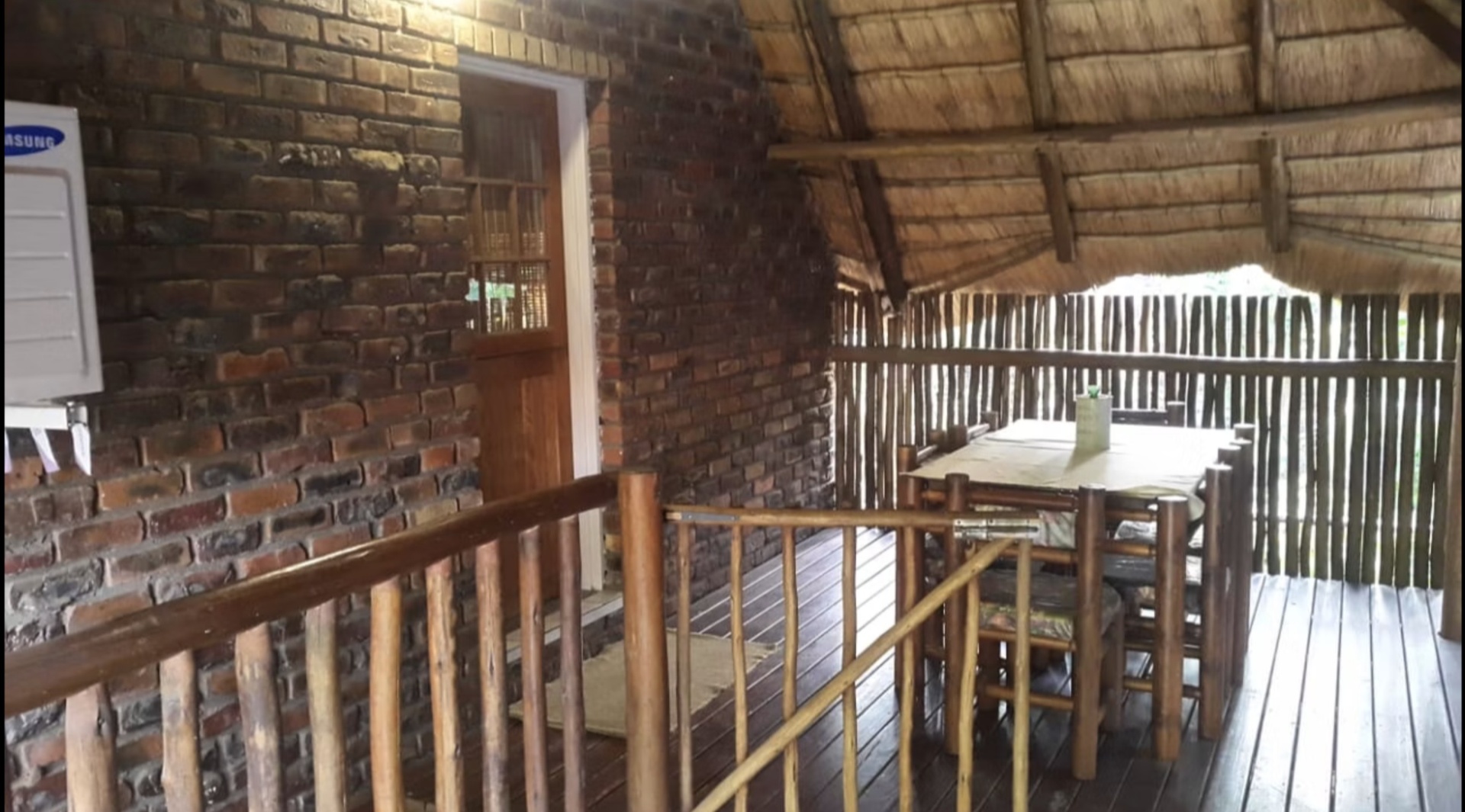 Covered thatched deck with dining table at Do-Drop-In Unit 3